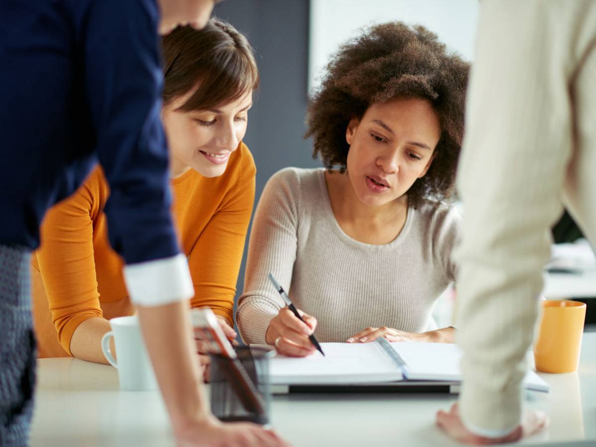 Young people working in modern office, brainstorming together