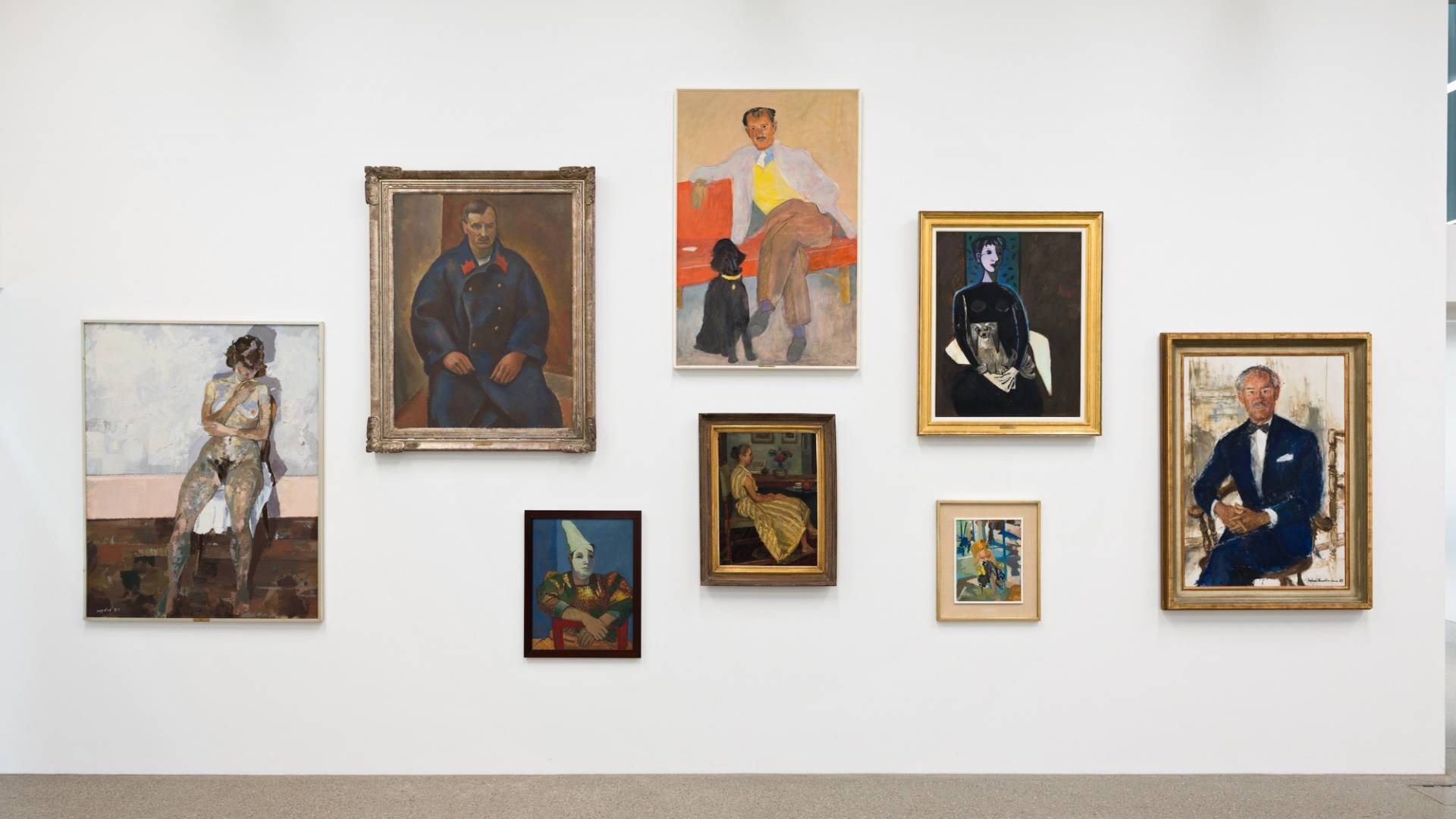 Acht stattlich gerahmte Gemälde, einer Ahnengalerie ähnelnd gruppiert. Sie zeigen Einzelporträts von Männern und Frauen, die sitzend für den Maler oder die Malerin posieren. 