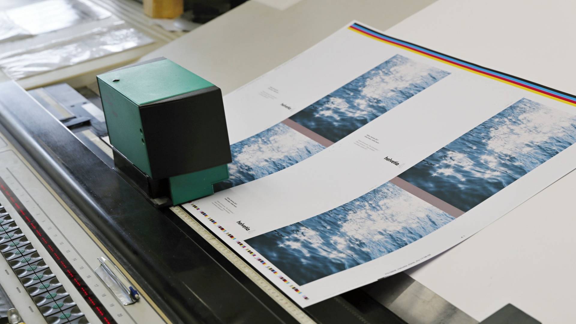 A device measuring the colour values on a printout of the artwork.