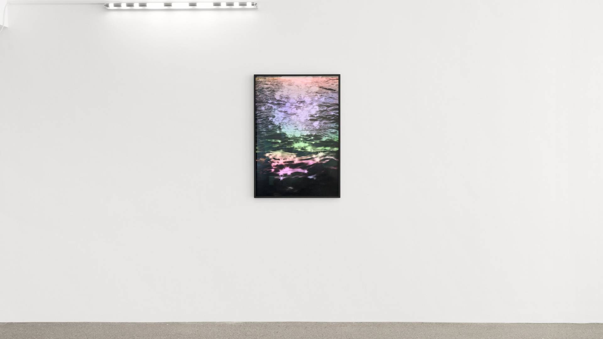 In the centre hangs a picture of the surface of a glittering, multi-coloured sea. Above this to the left a fluorescent tube represents the SOS international distress call.