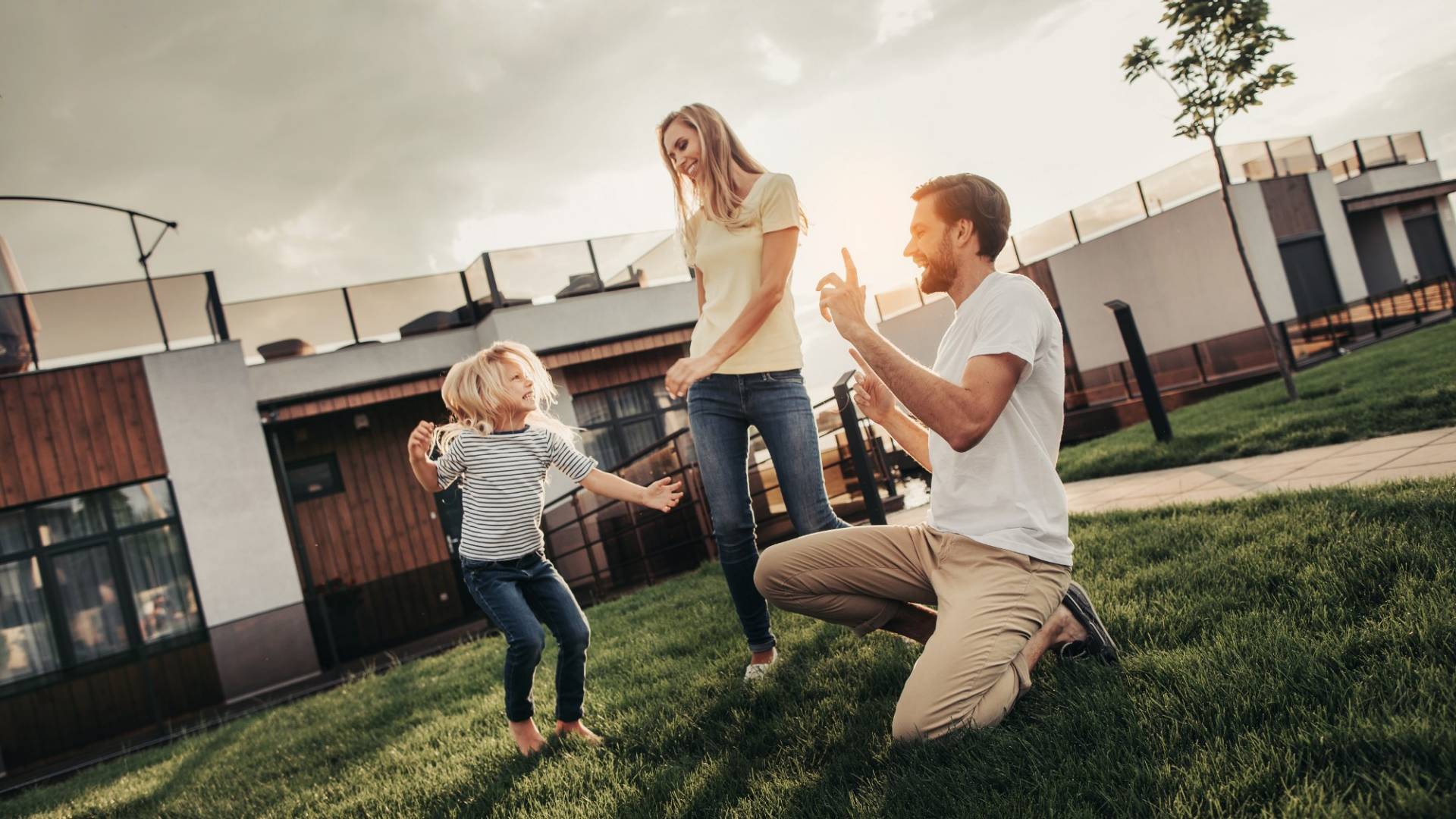 Positive couple with pleased child entertaining outdoor