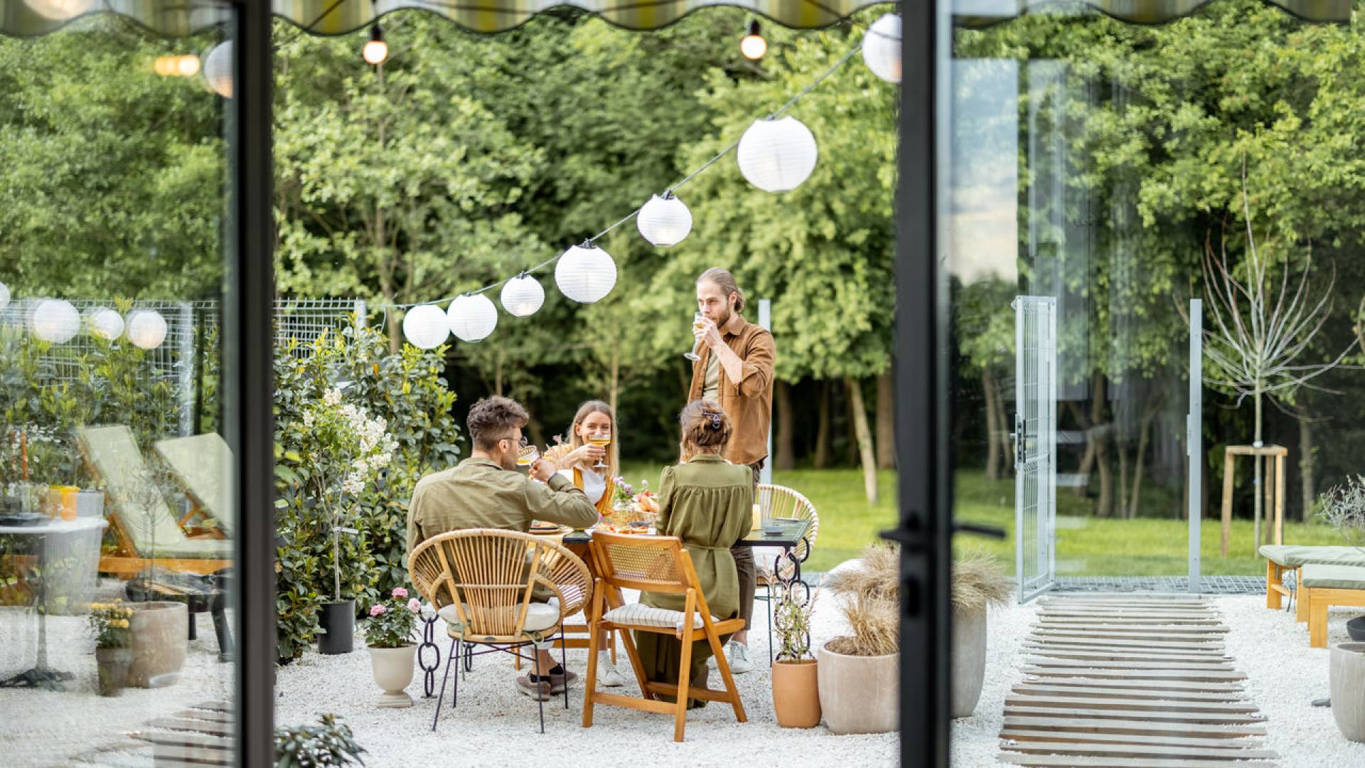 Friends having a festive dinner at backyard