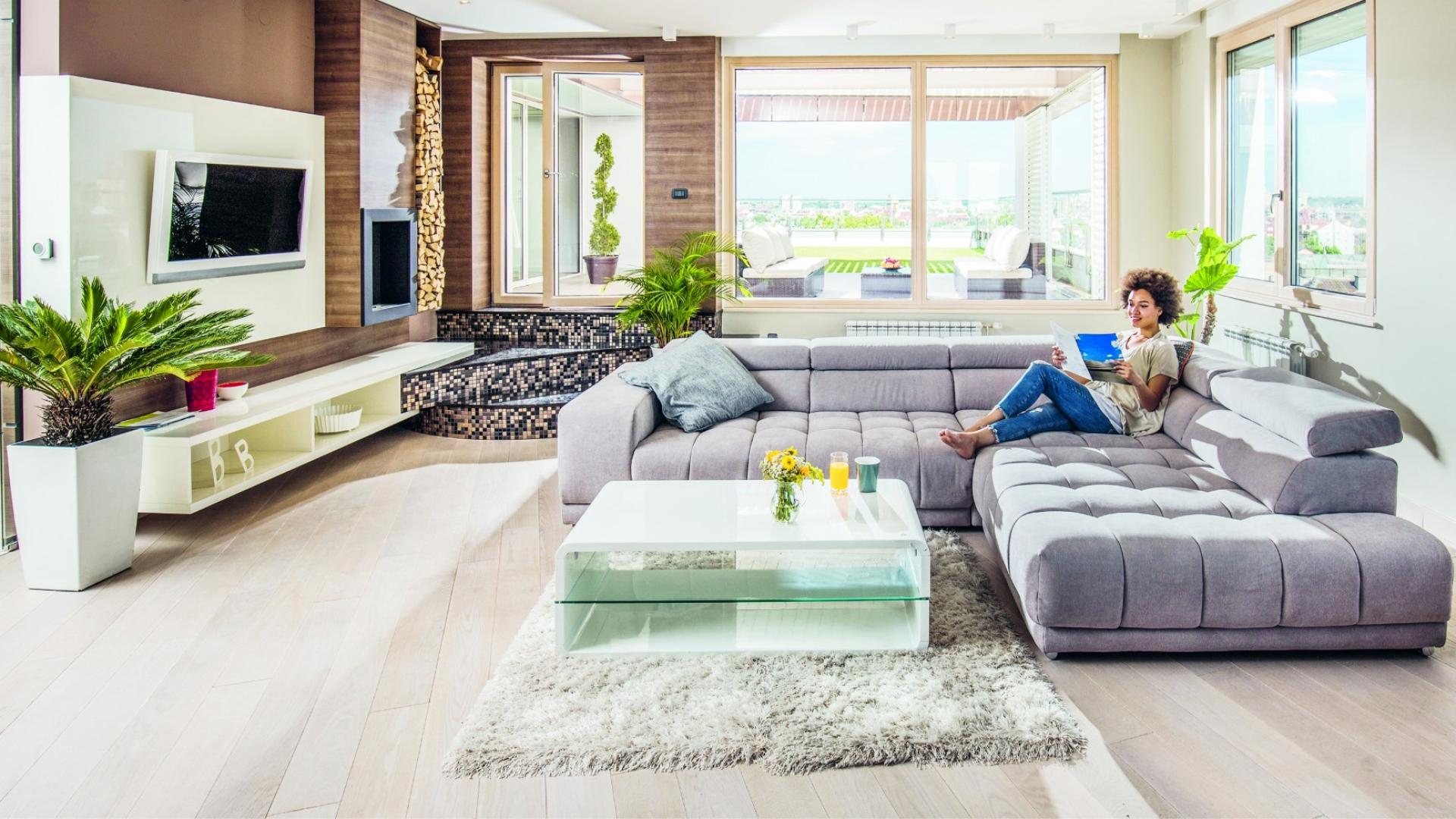 Ein Bügelbrett mit gefalteter Wösche und eine Waschmaschine im Hintergrund sind zu sehen.