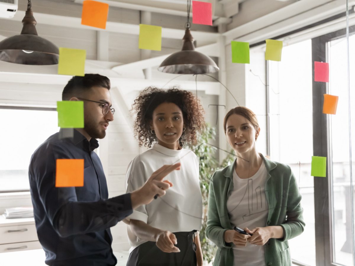 Multiracial colleagues develop ideas in office together