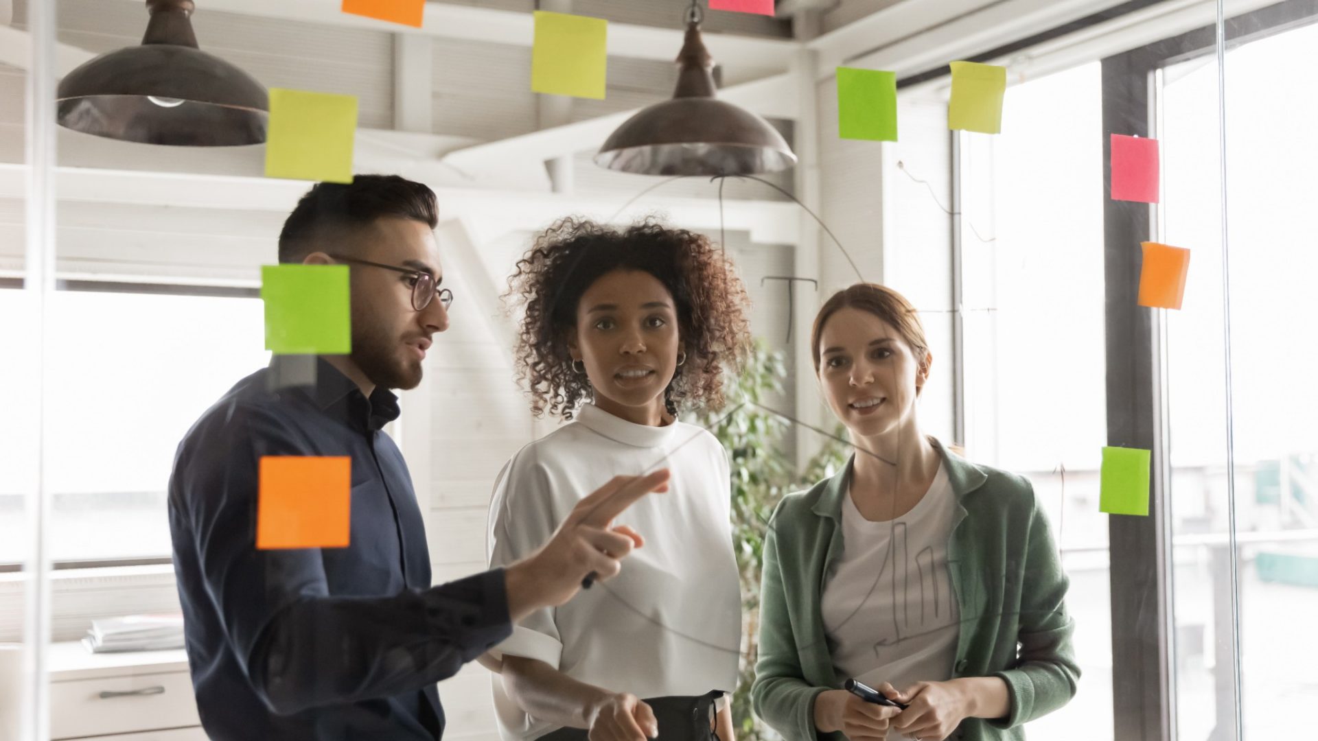 Multiracial colleagues develop ideas in office together